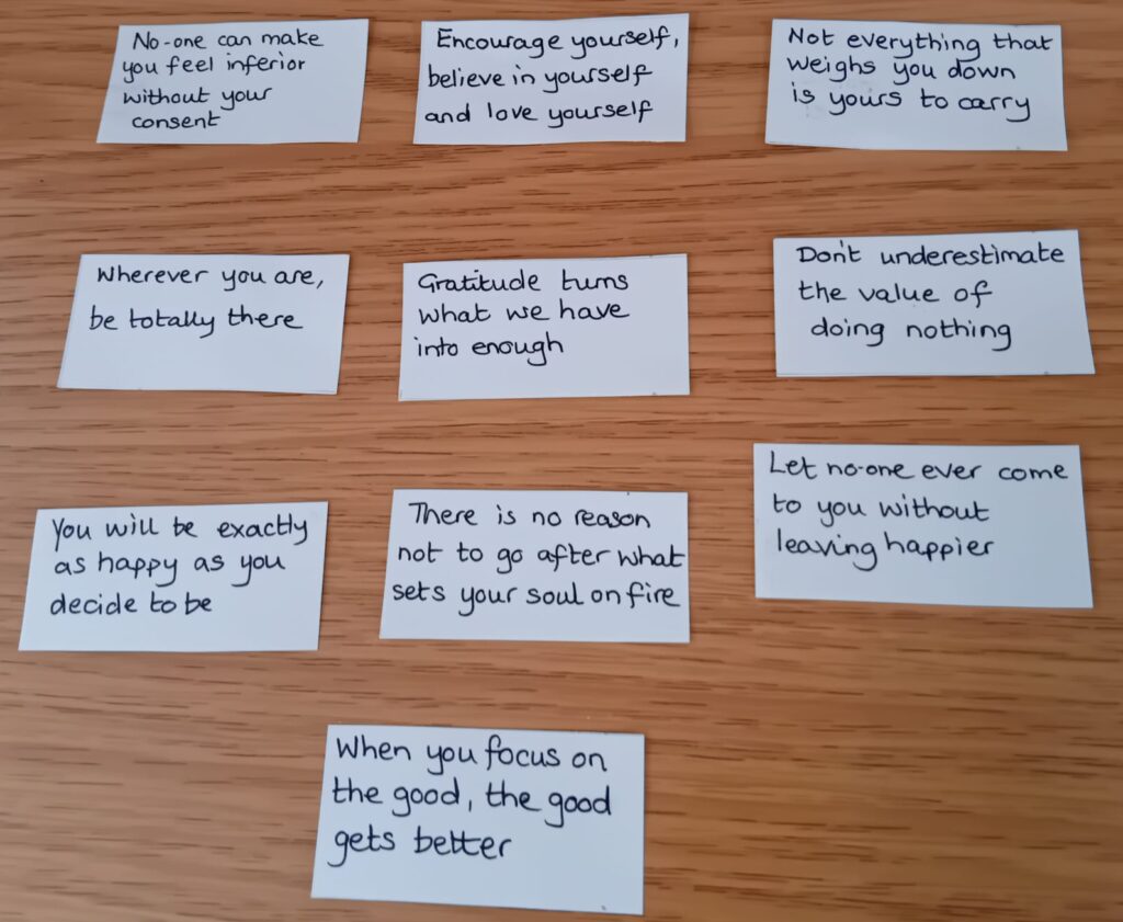 10 pieces of paper with positive phrases for wellbeing